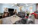 Spacious living room featuring high ceilings, ceiling fan, large windows, and modern furnishings at 251 Manous Way, Canton, GA 30115