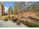 Cozy patio area with outdoor seating, a fire pit, and a view of the landscaped backyard at 251 Manous Way, Canton, GA 30115