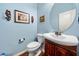 Charming powder room with round mirror and updated vanity at 251 Manous Way, Canton, GA 30115