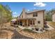 The backyard features a covered patio, fire pit, outdoor seating, and mature trees at 251 Manous Way, Canton, GA 30115