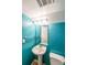 Stylish powder room with a pedestal sink and bright turquoise painted walls and a neutral toilet at 3530 Embry Cir, Atlanta, GA 30341