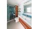 Modern bathroom featuring a glass-enclosed shower and wood grain vanity with a tile backsplash and accents at 3530 Embry Cir, Atlanta, GA 30341