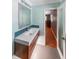 Contemporary bathroom with wood-look vanity with geometric floors and a shower door leading to the primary bedroom at 3530 Embry Cir, Atlanta, GA 30341