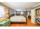 Spacious bedroom showcasing a four-poster bed, ceiling fan, wood floors and ample natural light at 3530 Embry Cir, Atlanta, GA 30341
