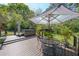 Secluded deck with a hot tub, table with chairs and a striped umbrella, offering a private outdoor space at 3530 Embry Cir, Atlanta, GA 30341