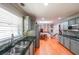 Bright, modern kitchen with hardwood floors, stainless appliances, tile backsplash, and stone countertops at 3530 Embry Cir, Atlanta, GA 30341