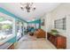 Well-lit sunroom with sliding doors, large windows, a comfortable couch, tiled floors, and white brick accent wall at 3530 Embry Cir, Atlanta, GA 30341