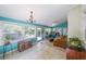 Bright sunroom featuring tiled flooring, many windows, and comfortable furniture for relaxing and enjoying natural light at 3530 Embry Cir, Atlanta, GA 30341
