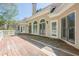 Large wooden back deck with plenty of space and natural light overlooks the backyard at 370 Royal Birkdale Ct, Johns Creek, GA 30097