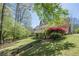 A spacious backyard with a patio and lush greenery creates a private retreat at 370 Royal Birkdale Ct, Johns Creek, GA 30097