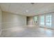 Spacious finished basement area with tile floors, double doors leading outside, and neutral walls at 370 Royal Birkdale Ct, Johns Creek, GA 30097