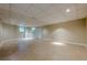 Finished basement featuring neutral colored walls, tile flooring, and natural light at 370 Royal Birkdale Ct, Johns Creek, GA 30097