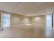 Large basement area with tile floors, neutral walls, doors, and a drop ceiling with recessed lights at 370 Royal Birkdale Ct, Johns Creek, GA 30097
