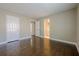 Bedroom boasts hardwood floors, neutral walls, and view to ensuite bathroom at 370 Royal Birkdale Ct, Johns Creek, GA 30097