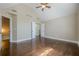 Bedroom with vaulted ceiling, wood floors, and ensuite bathroom with white cabinets at 370 Royal Birkdale Ct, Johns Creek, GA 30097