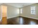 Bedroom features hardwood floors, windows with shutters, and a walk-in closet at 370 Royal Birkdale Ct, Johns Creek, GA 30097