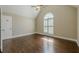 Bedroom with hardwood floors, a vaulted ceiling, and a large window with plantation shutters at 370 Royal Birkdale Ct, Johns Creek, GA 30097