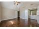 Bedroom features vaulted ceiling, wood floors, and ensuite bathroom with a white vanity at 370 Royal Birkdale Ct, Johns Creek, GA 30097