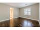 Bedroom with hardwood floors, windows with shutters, and view to ensuite bathroom at 370 Royal Birkdale Ct, Johns Creek, GA 30097