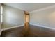 Neutral bedroom with hardwood floors, base molding, two windows with shutters, and tan walls at 370 Royal Birkdale Ct, Johns Creek, GA 30097