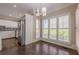 Cozy dining area adjacent to kitchen with plantation shutters and modern lighting at 370 Royal Birkdale Ct, Johns Creek, GA 30097