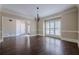 Dining room with dark hardwood floors, large windows, and decorative molding at 370 Royal Birkdale Ct, Johns Creek, GA 30097