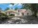 Charming home featuring a stone facade, arched entryway, and well-manicured landscaping, creating an inviting curb appeal at 370 Royal Birkdale Ct, Johns Creek, GA 30097
