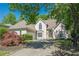 Well-maintained home with lush landscaping, manicured yard and driveway leading up to a charming stucco exterior at 370 Royal Birkdale Ct, Johns Creek, GA 30097