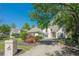 Attractive stucco home showcasing a manicured lawn and a stone mailbox with a decorative maple tree at 370 Royal Birkdale Ct, Johns Creek, GA 30097