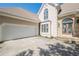 Close up of the entrance with the double door flanked by stone, with garage to the left at 370 Royal Birkdale Ct, Johns Creek, GA 30097