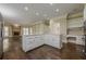 Open concept kitchen with white cabinets, granite countertops, and hardwood flooring at 370 Royal Birkdale Ct, Johns Creek, GA 30097