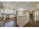 Modern kitchen with stainless steel appliances, island, and hardwood floors at 370 Royal Birkdale Ct, Johns Creek, GA 30097