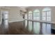 Open-concept living room featuring a staircase and expansive windows at 370 Royal Birkdale Ct, Johns Creek, GA 30097