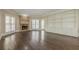 Bright living room with hardwood floors, built-in bookshelves, and a stone fireplace at 370 Royal Birkdale Ct, Johns Creek, GA 30097