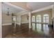 Spacious living room with hardwood floors, fireplace, abundant natural light, and elegant archways at 370 Royal Birkdale Ct, Johns Creek, GA 30097