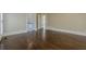 Neutral colored bedroom showing hardwood floors, base molding, door to bathroom and hall at 370 Royal Birkdale Ct, Johns Creek, GA 30097
