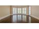 Spacious main bedroom with dark hardwood floors, large windows, and neutral wall colors at 370 Royal Birkdale Ct, Johns Creek, GA 30097