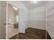Walk-in closet with hardwood floors and wire shelving connected to Primary bathroom at 370 Royal Birkdale Ct, Johns Creek, GA 30097