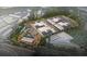 Aerial shot of a large commercial and industrial complex surrounded by a lush, green landscape at 4823 Layton Dr, Lithia Springs, GA 30122