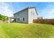 Large, level backyard featuring a covered patio, ideal for gatherings and outdoor activities at 4823 Layton Dr, Lithia Springs, GA 30122