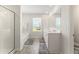 Bathroom featuring a tub, tiled floors, dual vanity sinks, and sleek glass shower, designed for comfort at 4823 Layton Dr, Lithia Springs, GA 30122