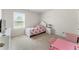Adorable bedroom with a princess theme, a white bed frame, a pink table and ample natural light at 4823 Layton Dr, Lithia Springs, GA 30122