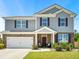 Beautiful two-story home with brick and siding, featuring a two-car garage and welcoming front porch at 4823 Layton Dr, Lithia Springs, GA 30122
