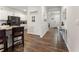 Hallway view of modern kitchen with stainless appliances and granite countertops adjacent to a decorated hallway at 4823 Layton Dr, Lithia Springs, GA 30122