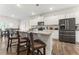 Modern kitchen with white cabinets, granite countertops, stainless steel appliances, and a breakfast bar at 4823 Layton Dr, Lithia Springs, GA 30122