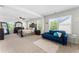 Bright main bedroom with large windows, plush seating area, and elegant furniture for a relaxing ambiance at 4823 Layton Dr, Lithia Springs, GA 30122