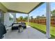 Relaxing covered patio with stylish outdoor furniture and a fire pit overlooking the fenced backyard at 4823 Layton Dr, Lithia Springs, GA 30122