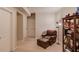 Cozy basement featuring neutral paint, a leather chair with ottoman, and a bookshelf for storage and decor at 5036 Maplecliff Dr, Sugar Hill, GA 30518