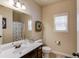 Bathroom with a large mirror, white vanity, toilet, shower and plenty of natural light at 5036 Maplecliff Dr, Sugar Hill, GA 30518