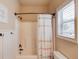 Bathroom featuring a shower and tub with a shower curtain and white tiled walls at 5036 Maplecliff Dr, Sugar Hill, GA 30518